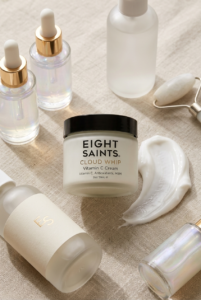 Luxury skincare flat lay featuring Eight Saints Cloud Whip Vitamin C Cream, facial serums, and clean beauty products in a soft neutral aesthetic.